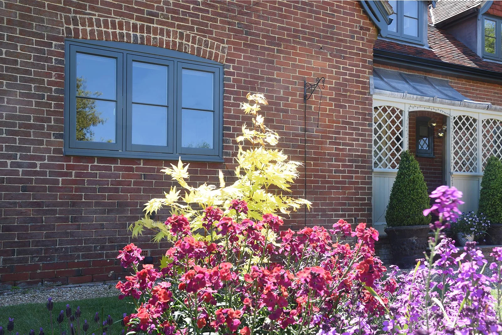 Timber-flush-casement-windows-finished-in-a-colour-complementary-to-Farrow-Ball-‘Downpipe